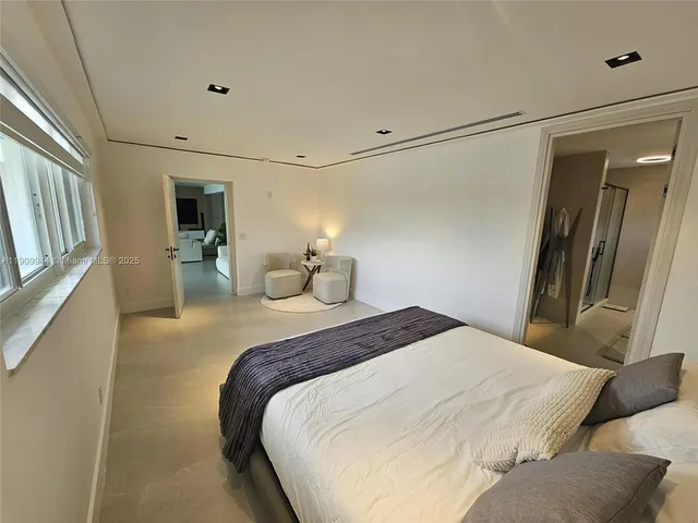a bedroom with a bed and a mirror