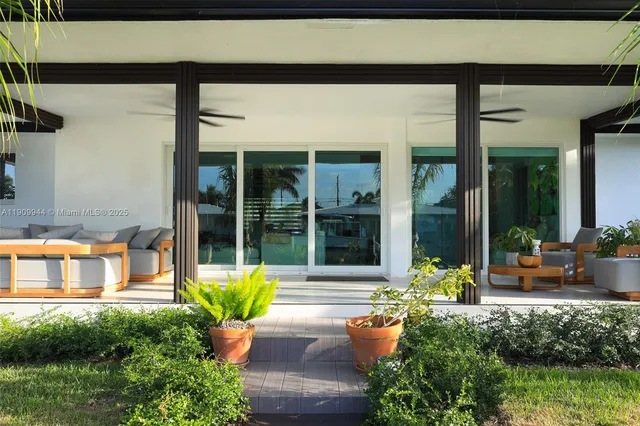 a house view with a sitting space and garden