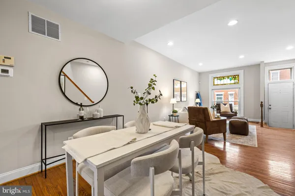 a view of a dining room with furniture and wooden floor