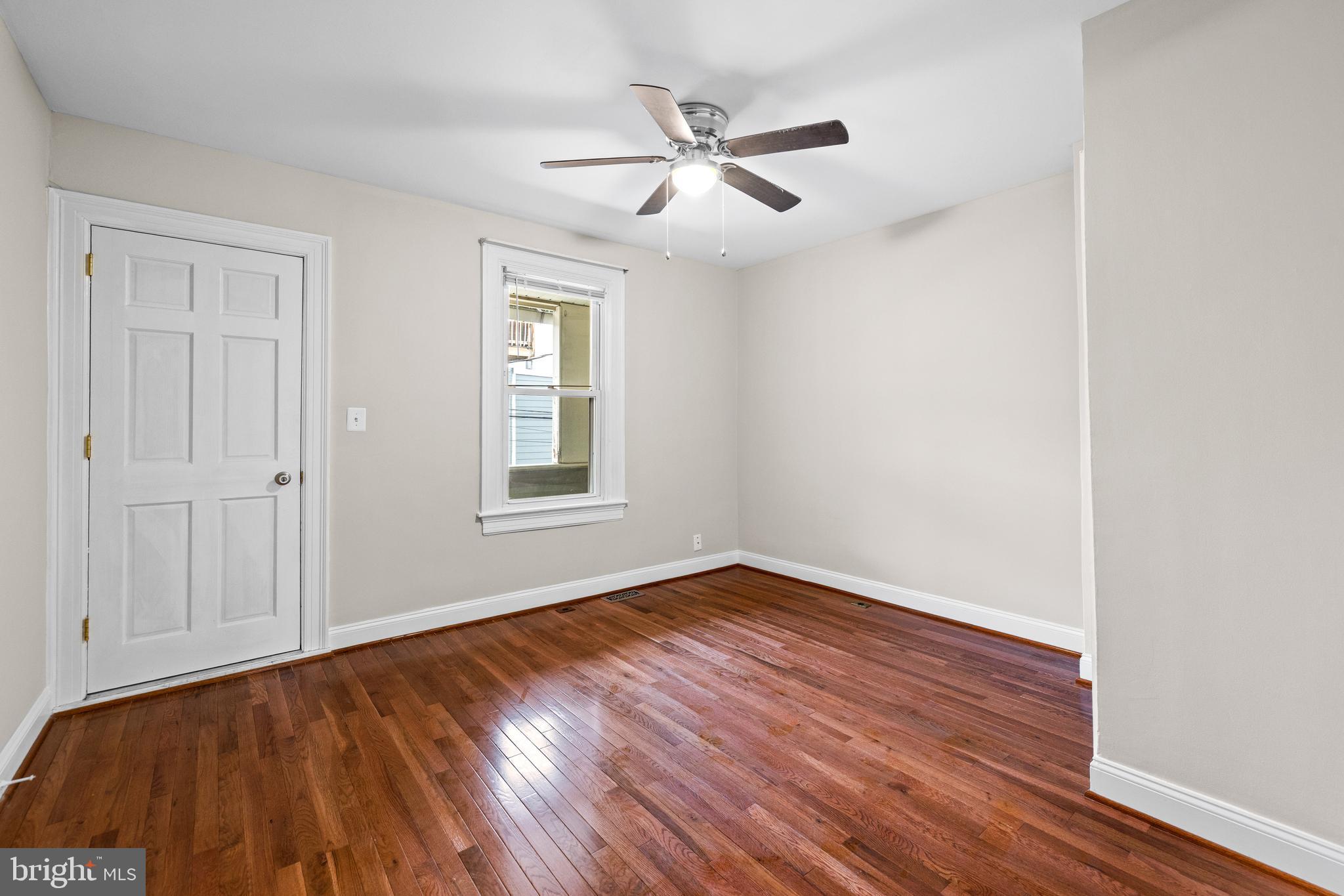 3702 Foster Avenue Baltimore, MD 21224 - Photo 21 of 39 wooden floor in an empty room with a window
