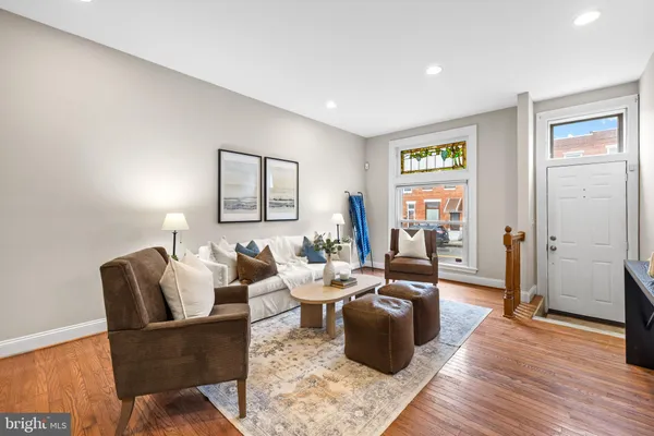 a living room with furniture and wooden floor