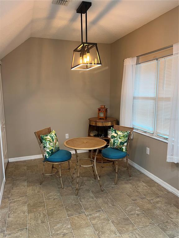 3803 Herlong Street New Port Richey, FL 34655 - Photo 8 of 22 a view of a dining room with furniture a chandelier and wooden floor