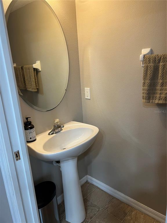3803 Herlong Street New Port Richey, FL 34655 - Photo 9 of 22 a bathroom with a sink and mirror