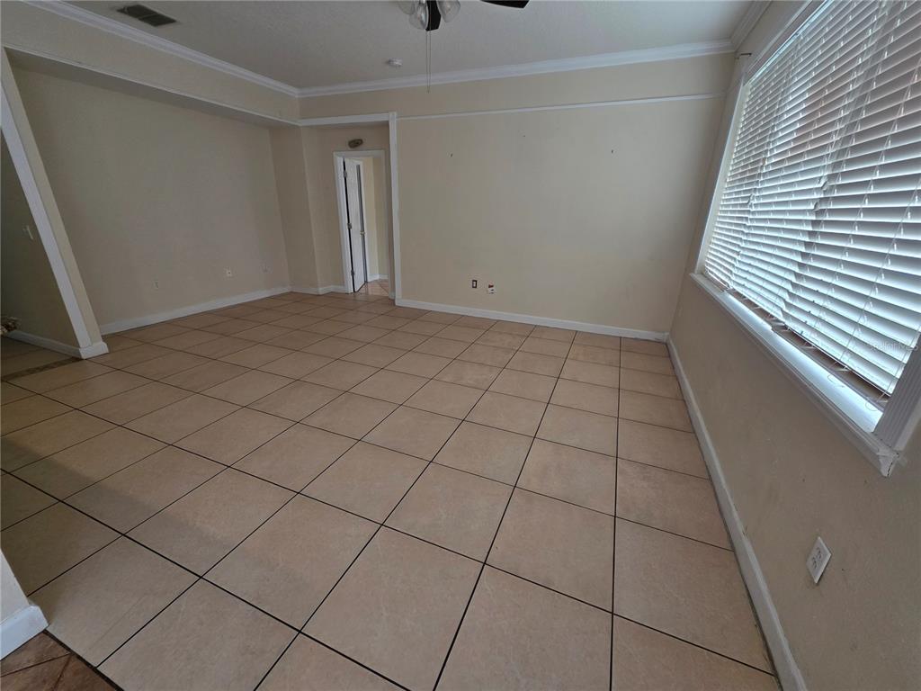 830 Neptune Pointe Lane Kissimmee, FL 34744 - Photo 5 of 10 a view of an empty room and a window