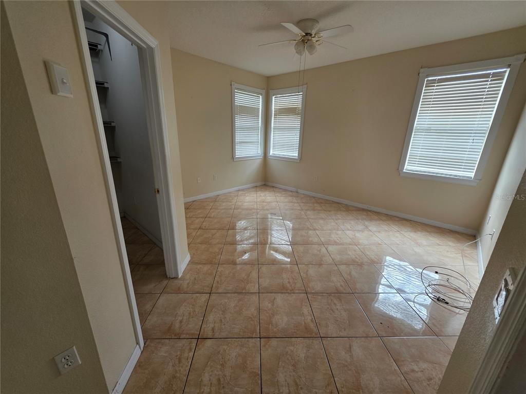 830 Neptune Pointe Lane Kissimmee, FL 34744 - Photo 6 of 10 a view of an empty room and window
