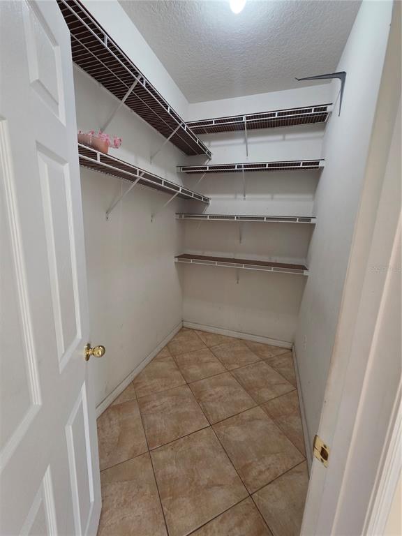 830 Neptune Pointe Lane Kissimmee, FL 34744 - Photo 7 of 10 a view of walk in closet with empty racks