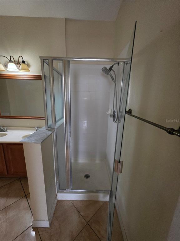 830 Neptune Pointe Lane Kissimmee, FL 34744 - Photo 9 of 10 a bathroom with a shower and a mirror