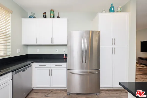 a white refrigerator freezer sitting in a kitchen