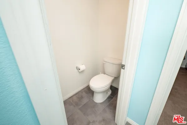 a white toilet sitting next to a shower