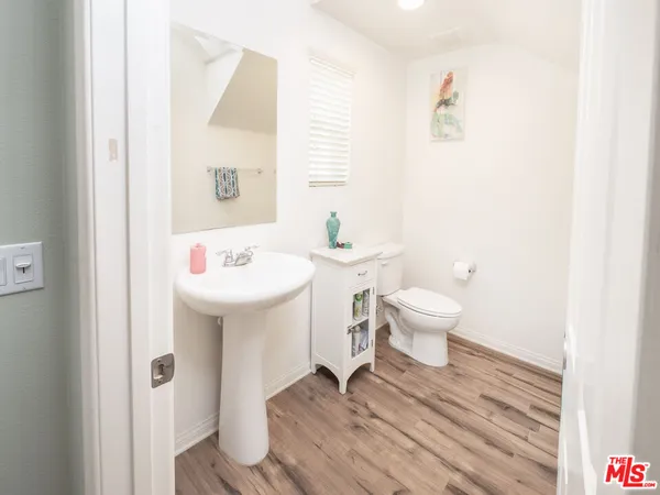 a bathroom with a sink toilet and a mirror