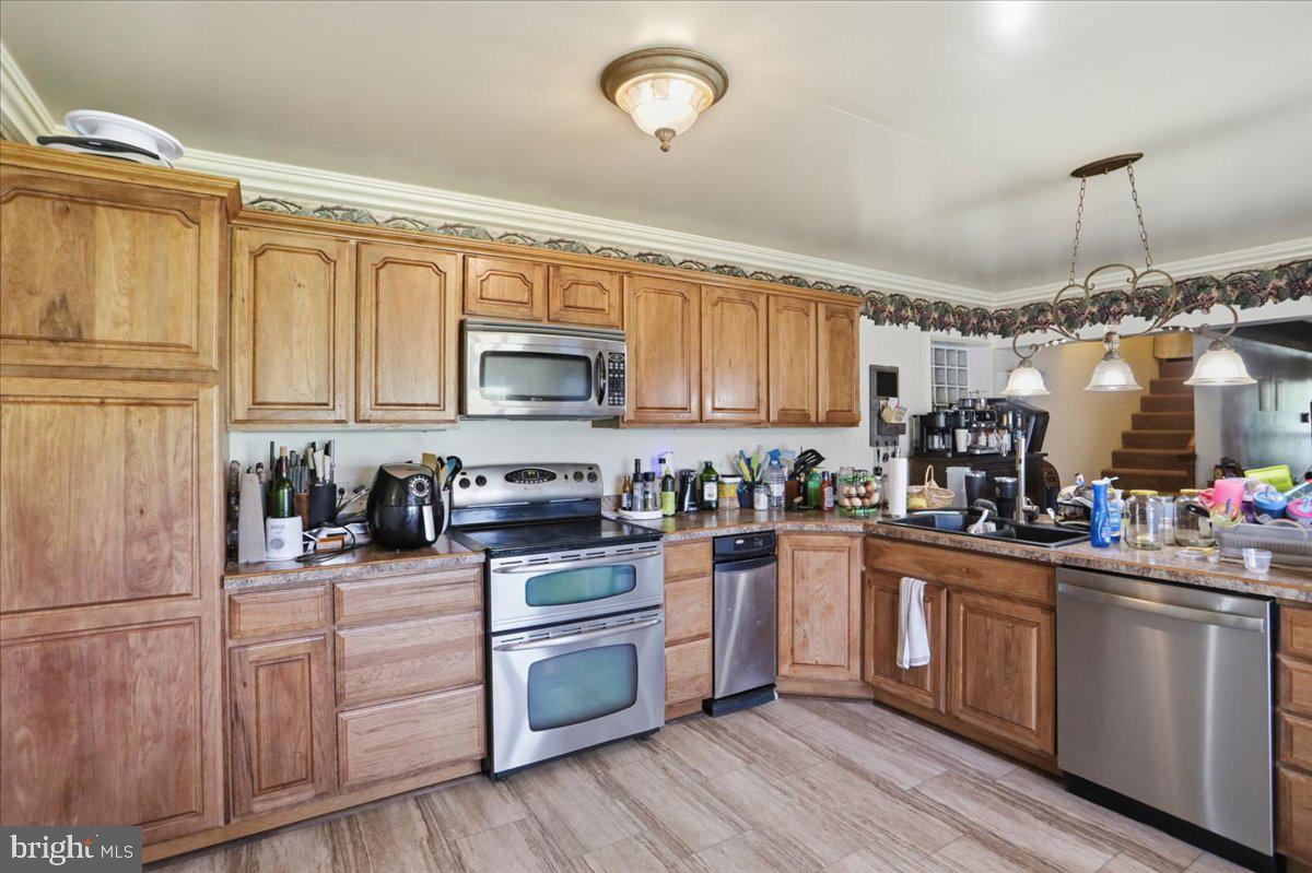 1264 Tearcoat Road Augusta, WV 26704 - Photo 11 of 43 a kitchen with kitchen island granite countertop a sink cabinets stainless steel appliances and a counter space