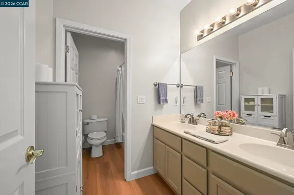 a bathroom with a double vanity sink toilet and shower