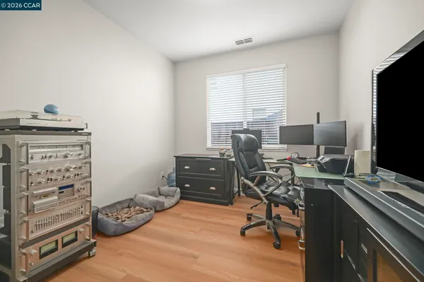 a view of a workspace with furniture and a window