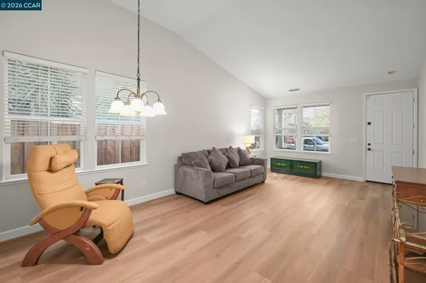 a living room with furniture and a chandelier