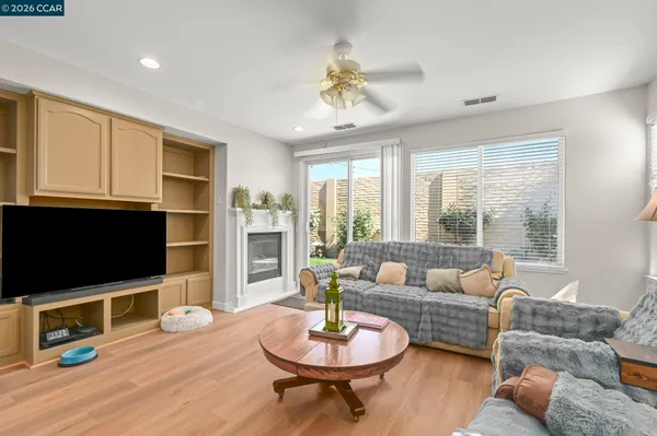 a living room with furniture a flat screen tv and a large window