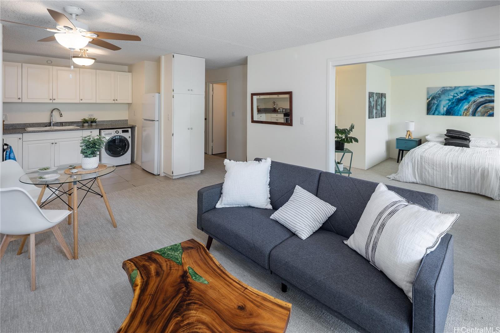 1615 Wilder Avenue, Unit 507 Honolulu, HI 96822 - Photo 1 of 20 a living room with furniture and a chandelier