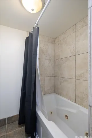a bathroom with a shower and bathtub