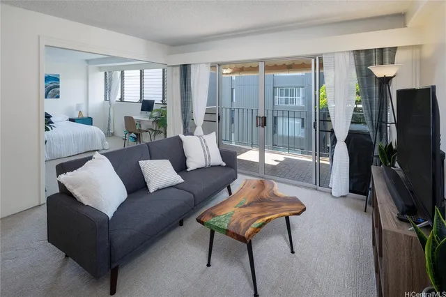 a living room with furniture a large window and a flat screen tv