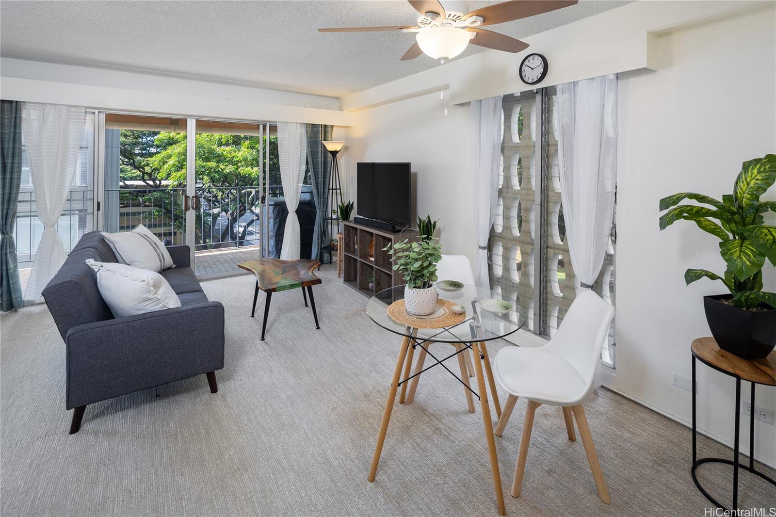 1615 Wilder Avenue, Unit 507 Honolulu, HI 96822 - Photo 4 of 20 a living room with furniture and a flat screen tv