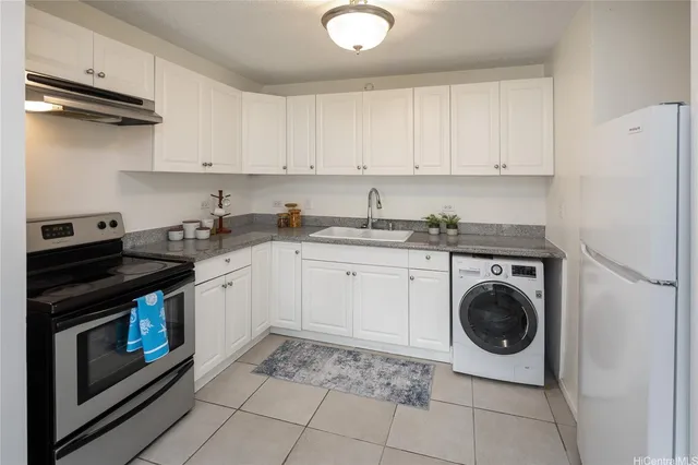 a kitchen with a stove top oven sink and cabinets