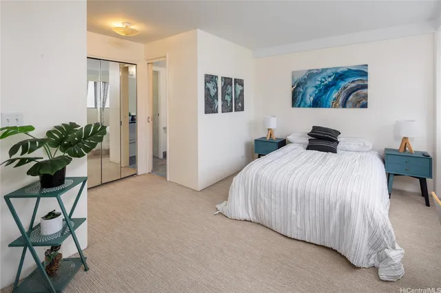 a bedroom with a bed and potted plant