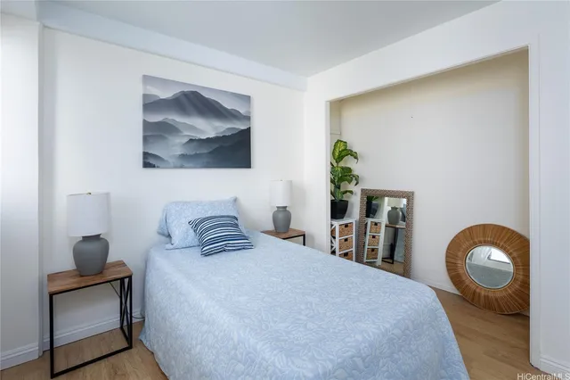a bedroom with a bed and a painting on the wall