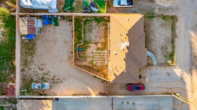 an aerial view of a house with garden space and parking