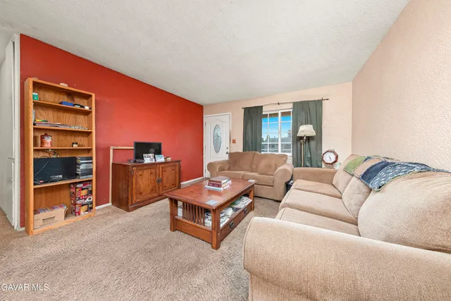 a living room with furniture and a kitchen view