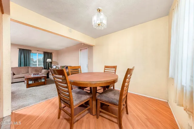 a view of a dining room with furniture and a chandelier