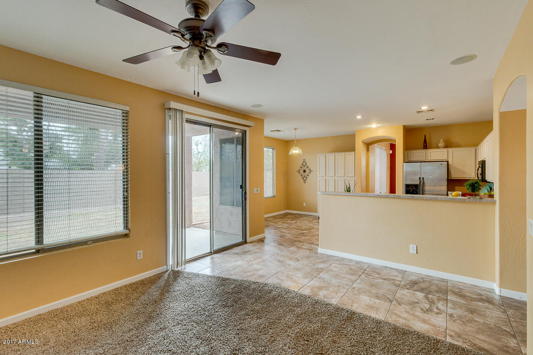 2803 West Lamar Road Phoenix, AZ 85017 - Photo 11 of 47 a view of a livingroom with a chandelier fan and windows