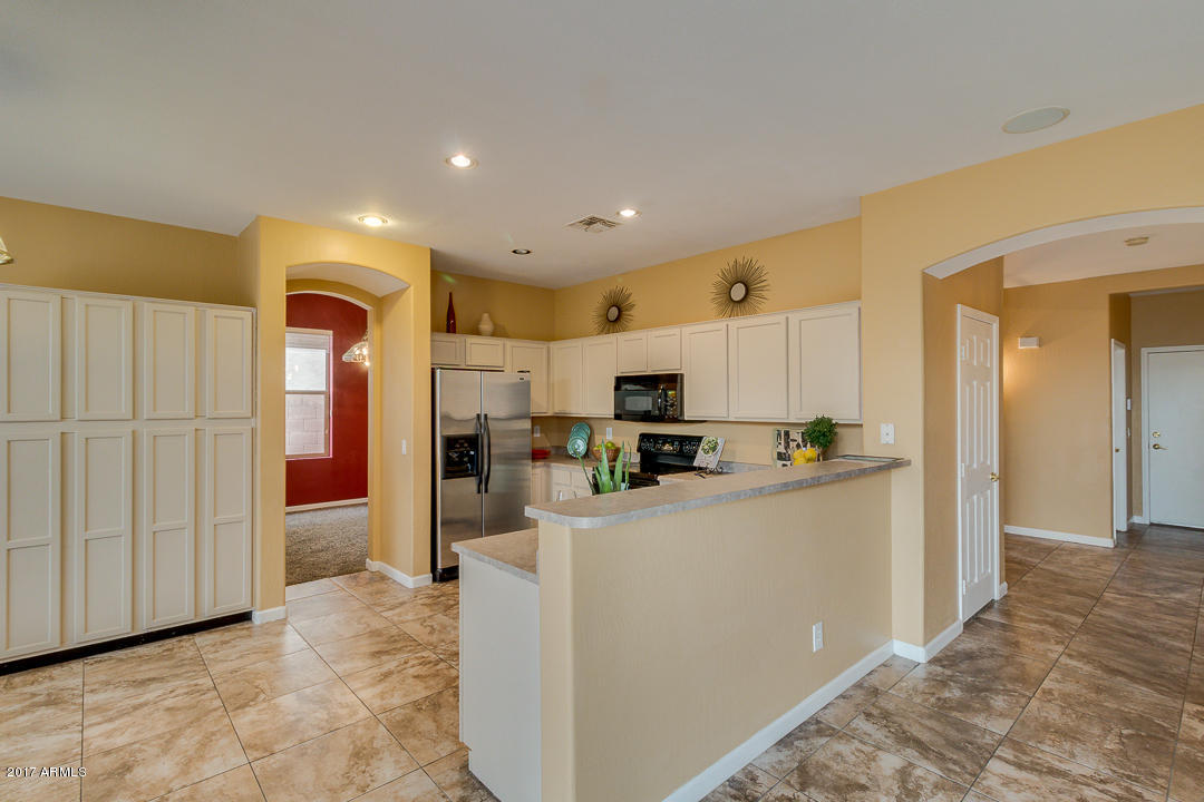 2803 West Lamar Road Phoenix, AZ 85017 - Photo 17 of 47 a kitchen with stainless steel appliances a refrigerator and a stove top oven
