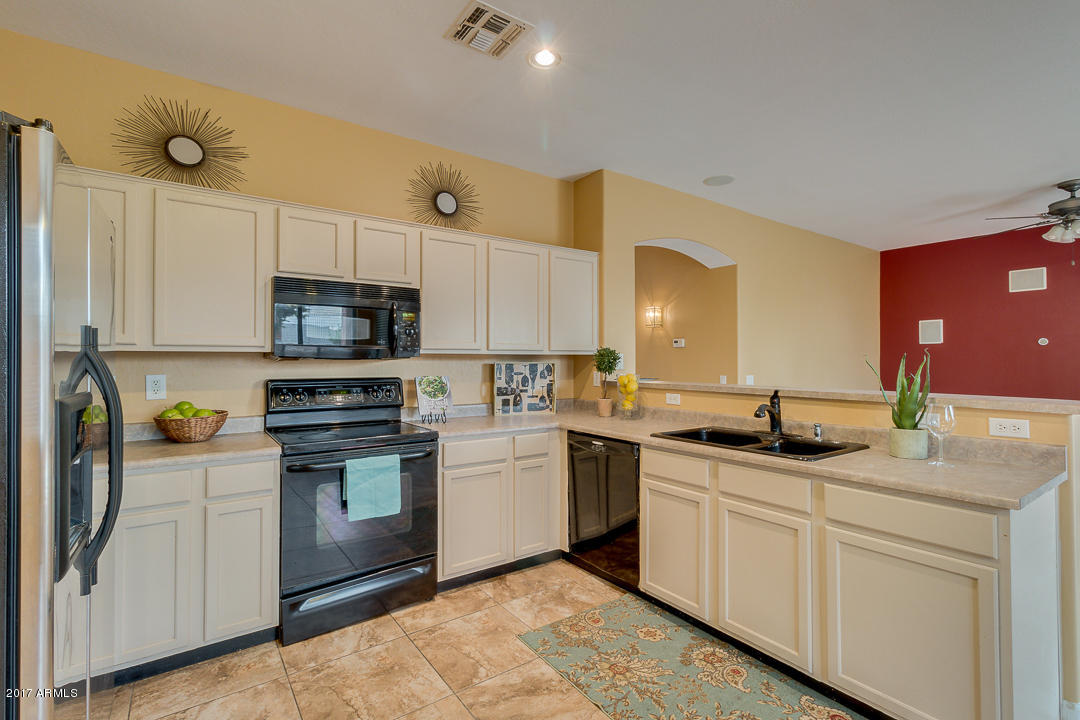 2803 West Lamar Road Phoenix, AZ 85017 - Photo 20 of 47 a kitchen with a sink stove and cabinets