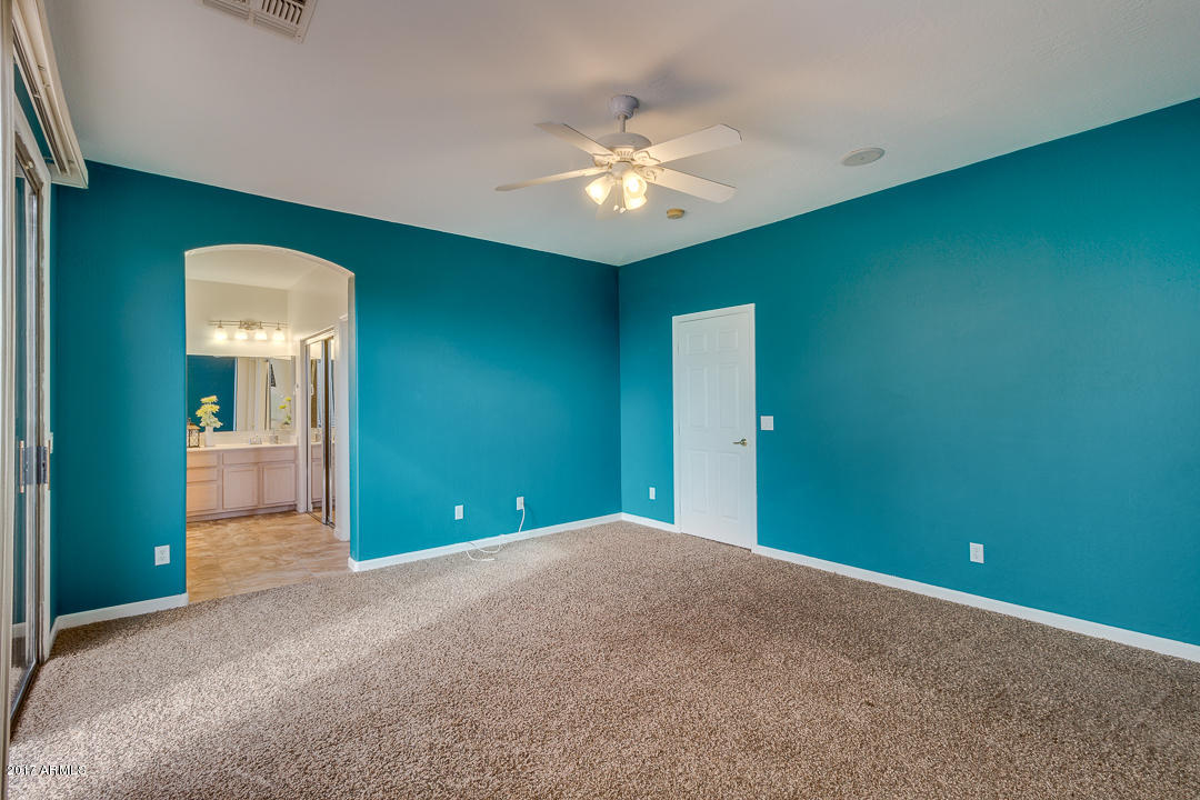 2803 West Lamar Road Phoenix, AZ 85017 - Photo 23 of 47 a view of a room with a chandelier fan and windows