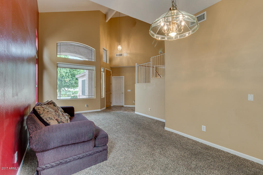 2803 West Lamar Road Phoenix, AZ 85017 - Photo 6 of 47 a living room with furniture and a chandelier