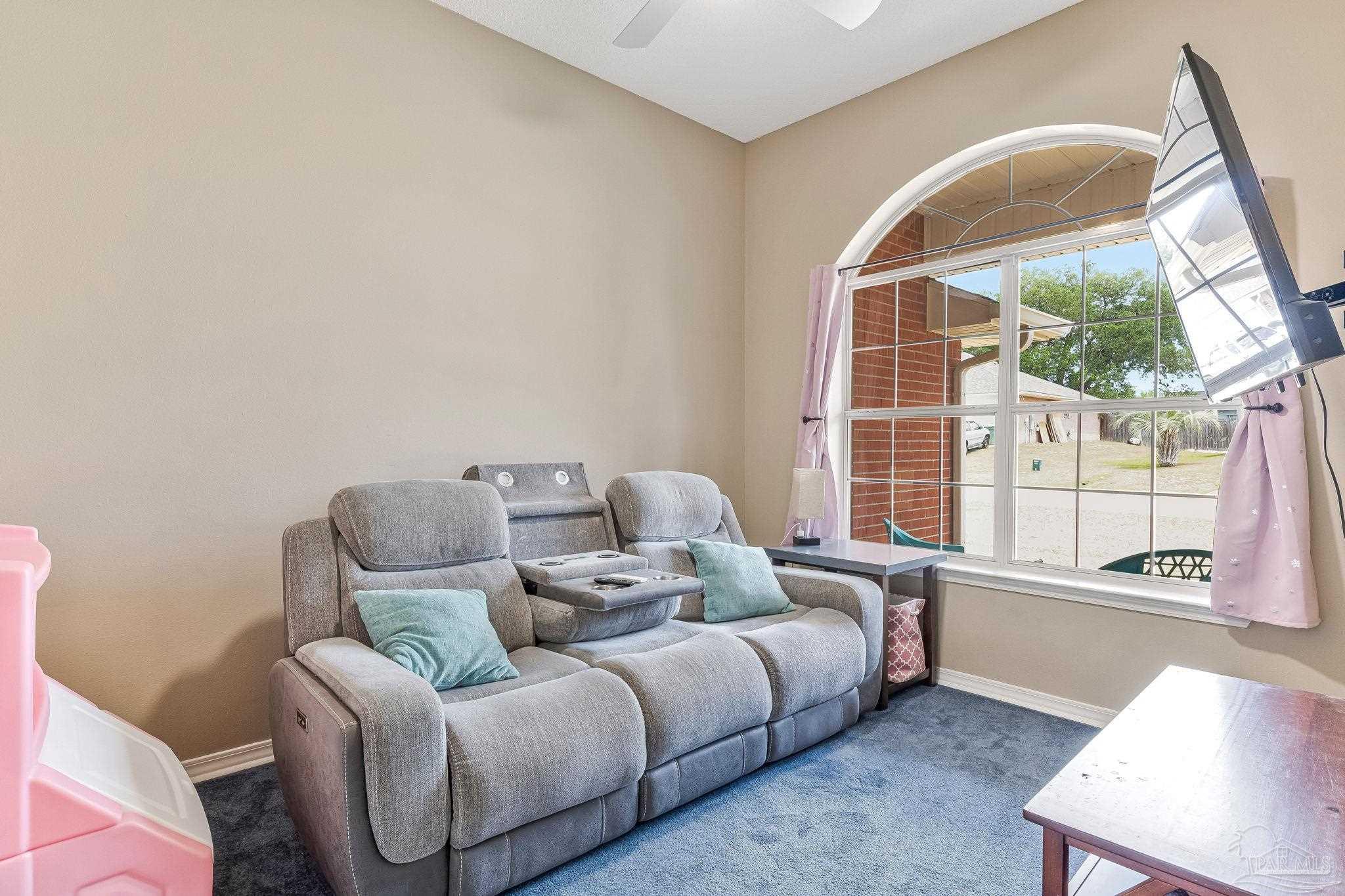 7121 Woodside Road Pensacola, FL 32526 - Photo 20 of 69 a bedroom with furniture and a large window