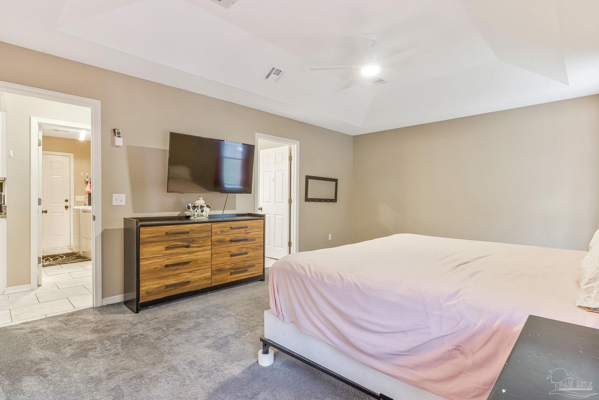 7121 Woodside Road Pensacola, FL 32526 - Photo 22 of 69 a bedroom with a bed and a flat screen tv