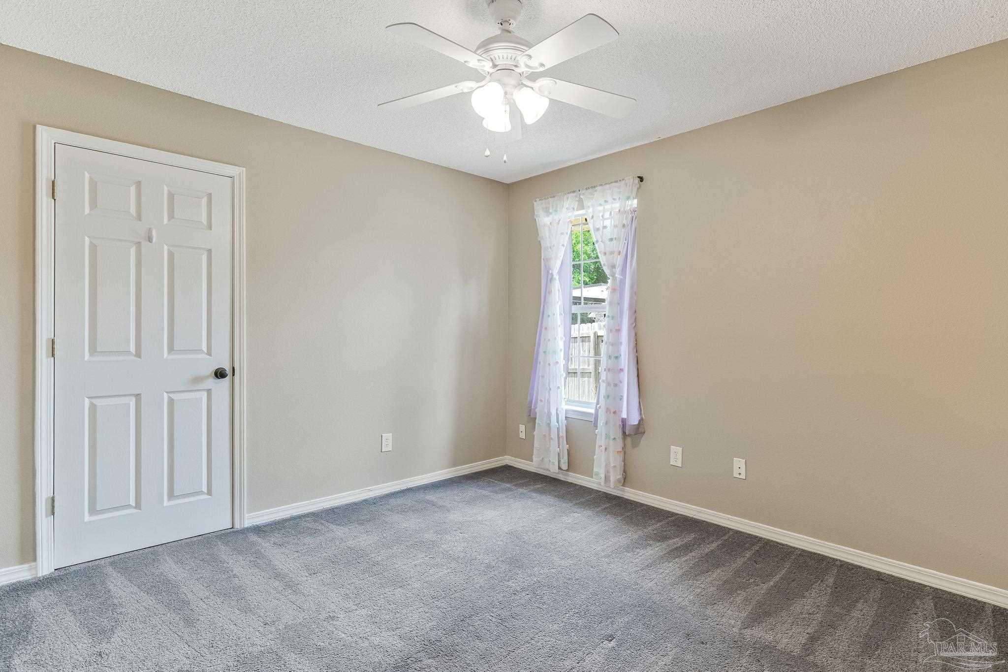 7121 Woodside Road Pensacola, FL 32526 - Photo 32 of 69 an empty room with closet and a chandelier fan