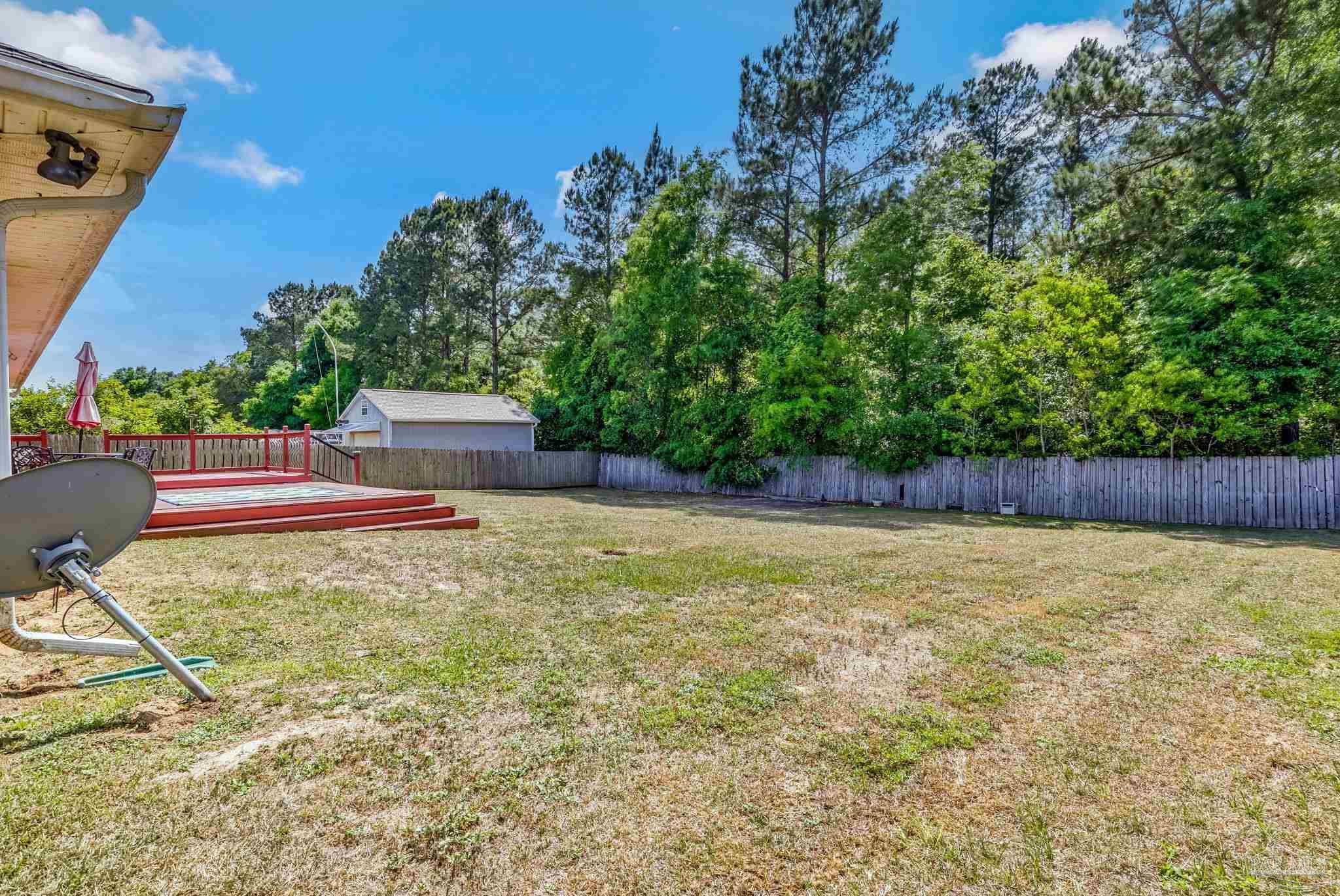 7121 Woodside Road Pensacola, FL 32526 - Photo 57 of 69 a backyard of a house with lots of green space