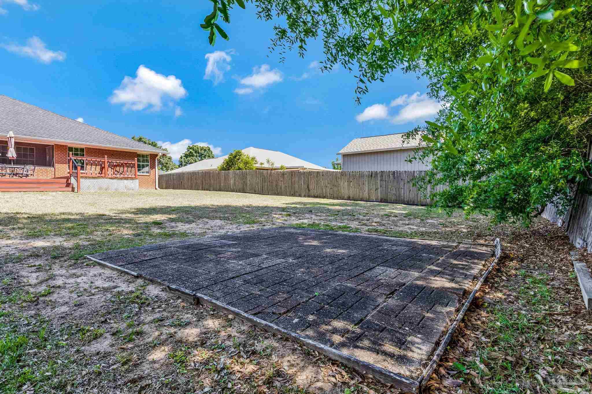 7121 Woodside Road Pensacola, FL 32526 - Photo 60 of 69 a view of a yard with a house in the background