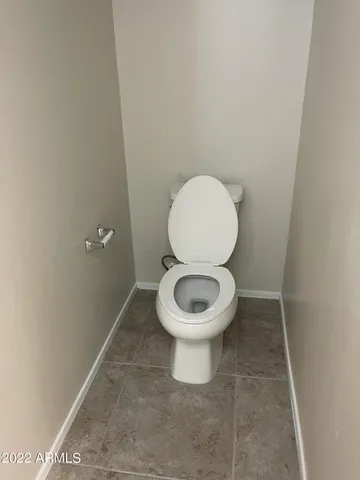 a white toilet sitting in a bathroom