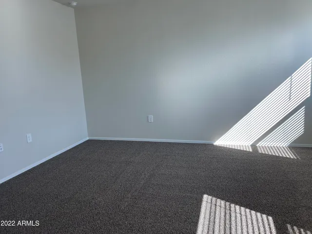 a view of an empty room and wooden floor