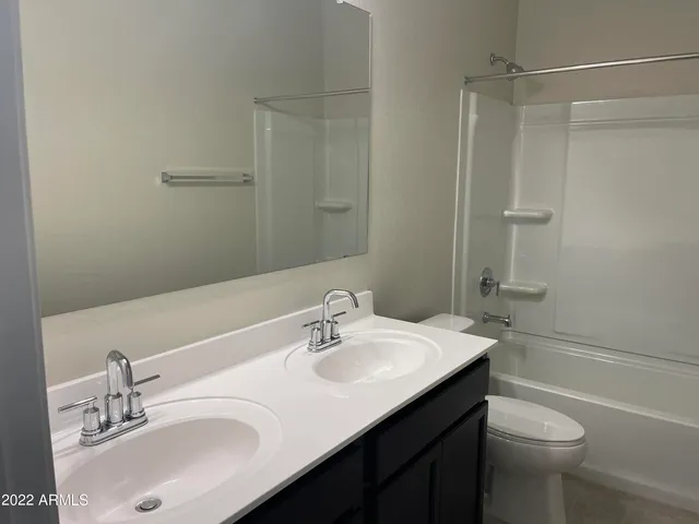a bathroom with a sink toilet tub and shower