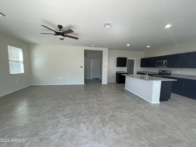 a view of a kitchen with a sink stainless steel appliances and cabinets