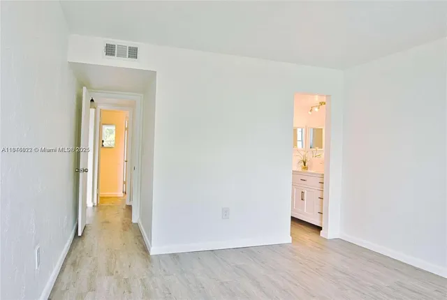 a view of a room with wooden floor