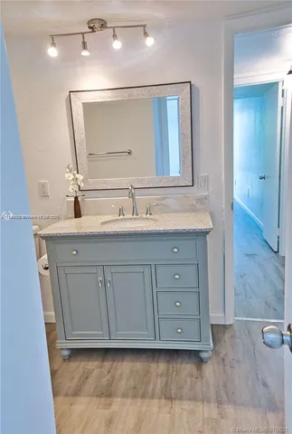 a bathroom with a sink a mirror and a vanity