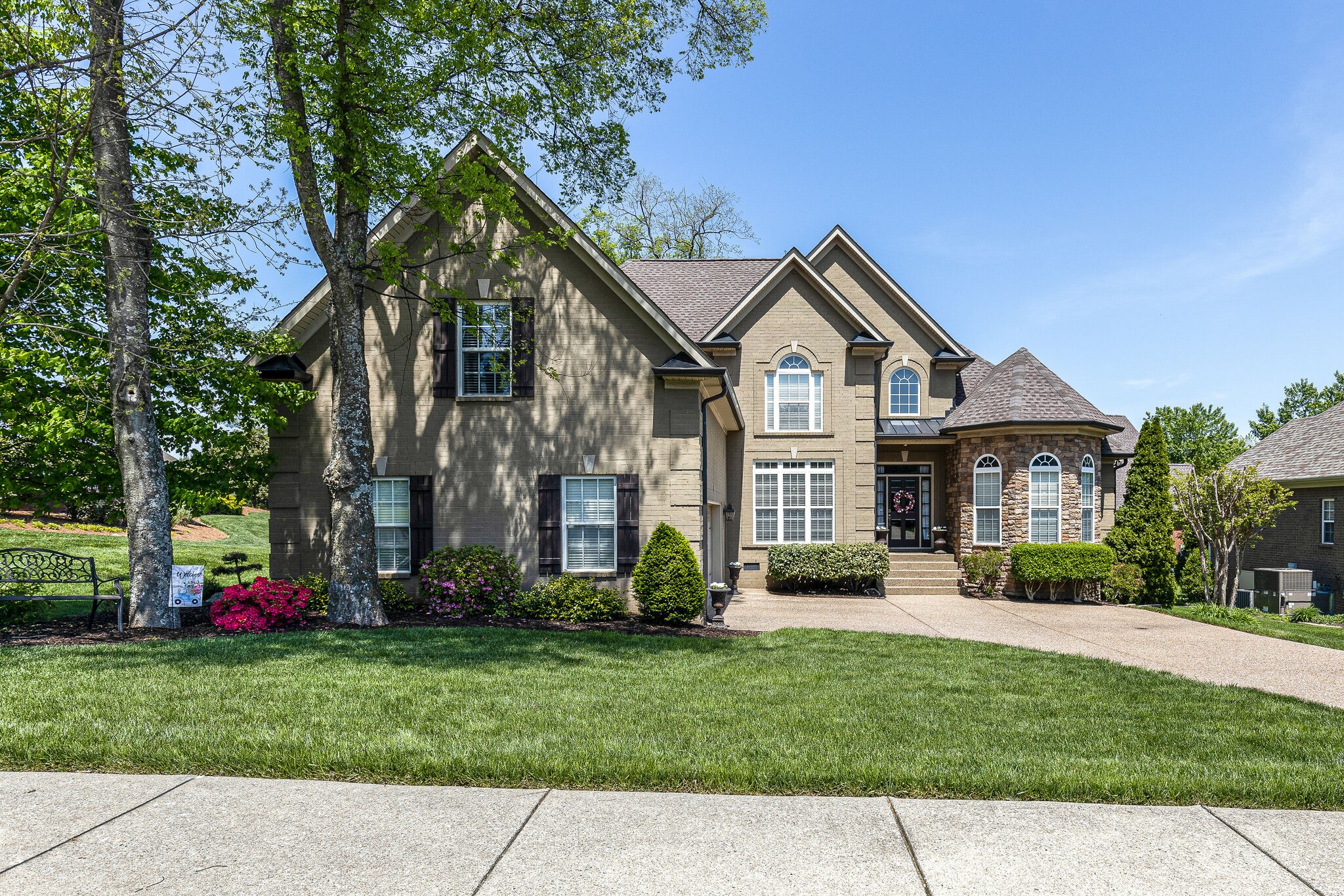 a front view of a house with a garden and plants