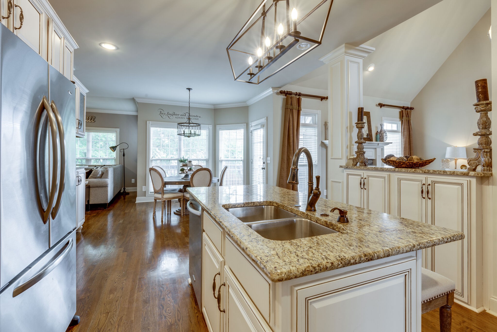 3012 Stewart Campbell Pointe Spring Hill, TN 37174 - Photo 14 of 44 a kitchen with stainless steel appliances granite countertop a sink a stove and a wooden floors
