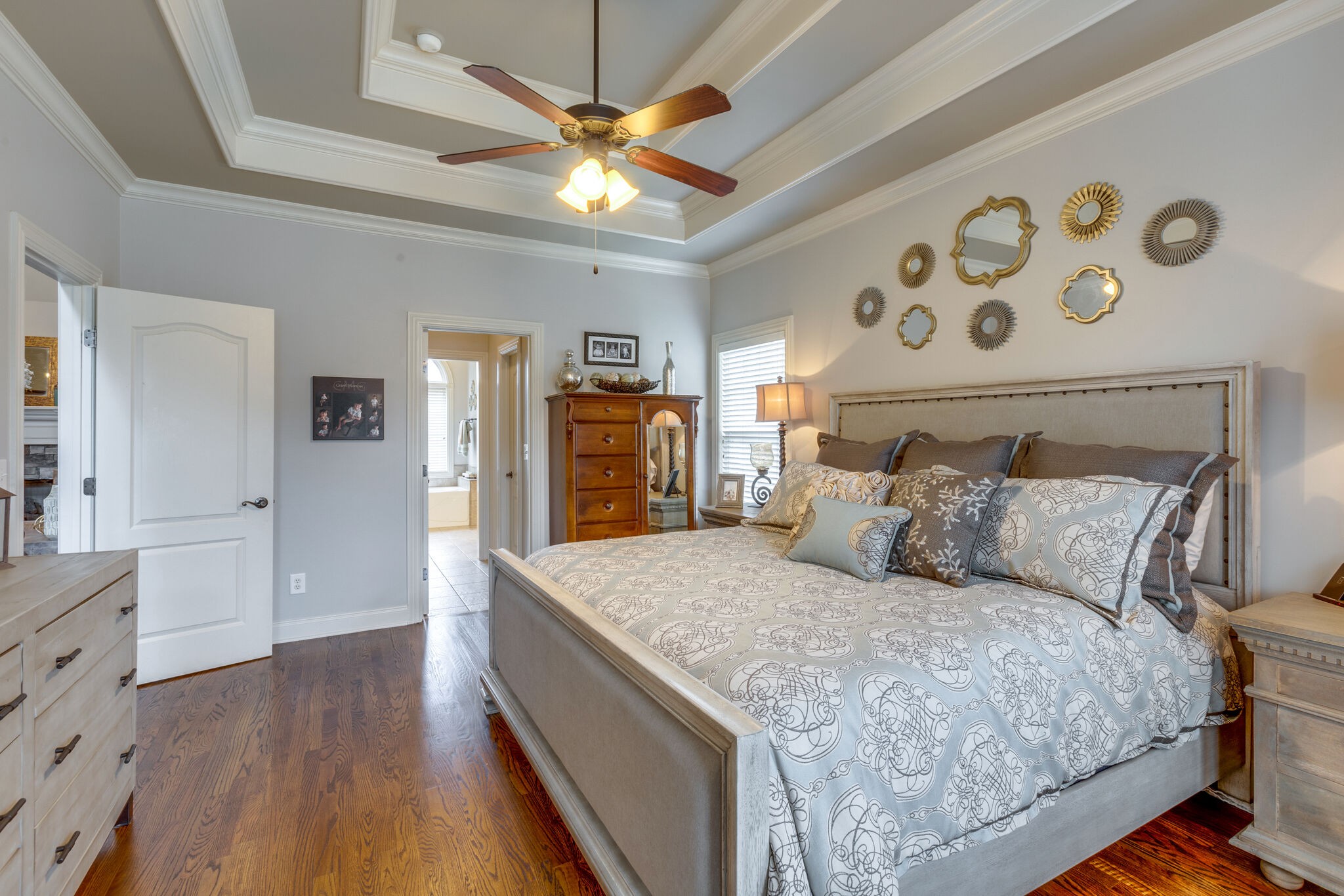 3012 Stewart Campbell Pointe Spring Hill, TN 37174 - Photo 22 of 44 a bedroom with a large bed and a chandelier
