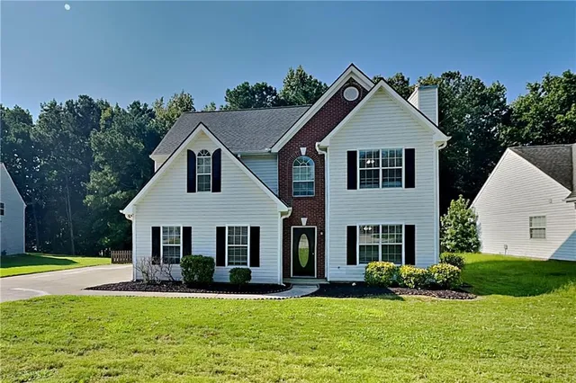 a front view of a house with a yard