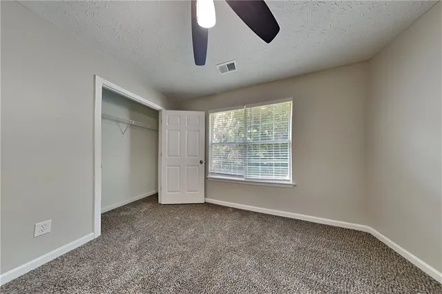 an empty room with a empty space and windows